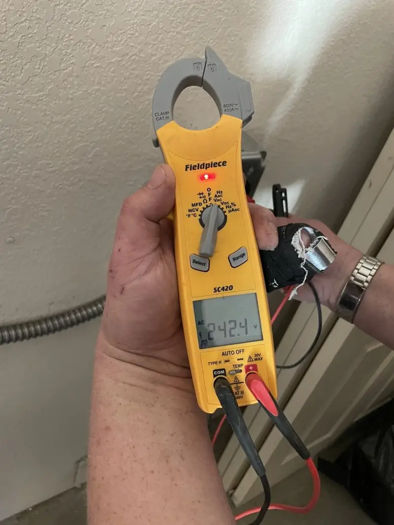 Voltage testing with clamp meter during Whole House Surge Protector in East Troy